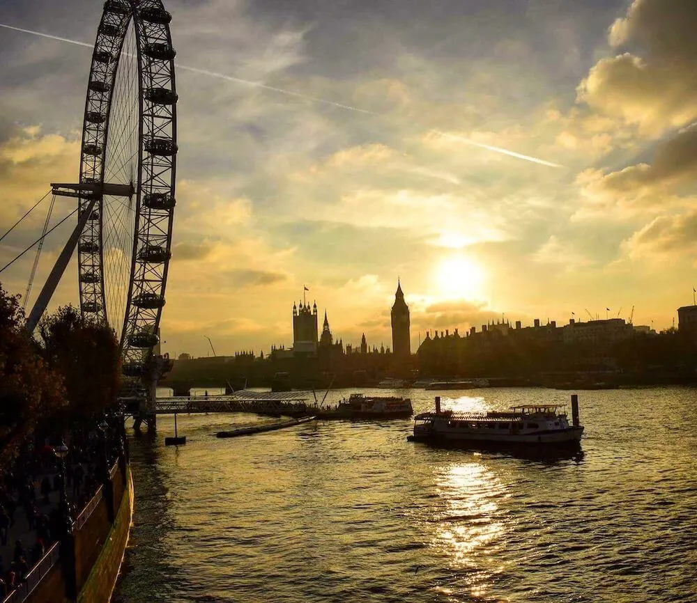 Golden hour over the London Eye and Westminster in London, UK