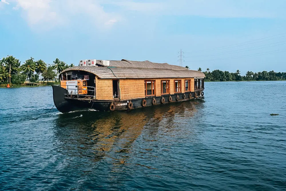 A typical kettuvallom boat cruises the backwaters of Kerala, India