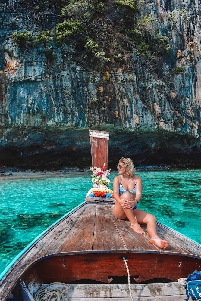 Island hopping with a typical wooden long tail boat in the Phi Phi Islands, Thailand