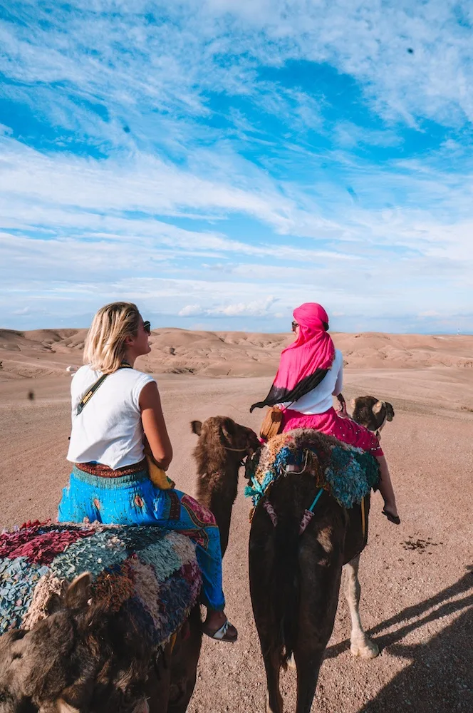 Going for a camel ride in the Agafay desert at Scarabeo Camp, Morocco