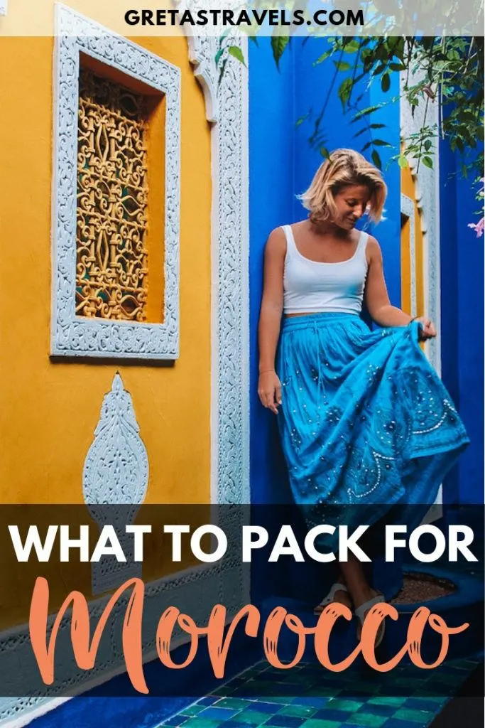 Blonde girl in a blue skirt standing in front of one of the blue walls of Jardin Majorelle in Marrakech, with text overlay saying "what to pack for Morocco"