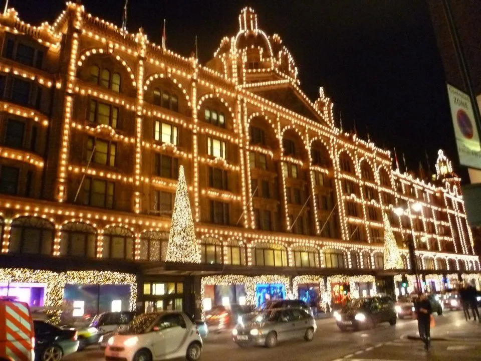 Harrods, the iconic shopping mall in London, at night with all the facade lit up for Christmas