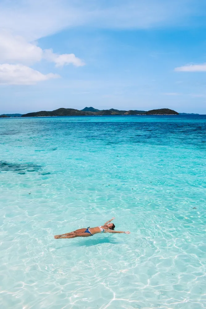 Floating in the clear turquoise water of Malcapuya Island 