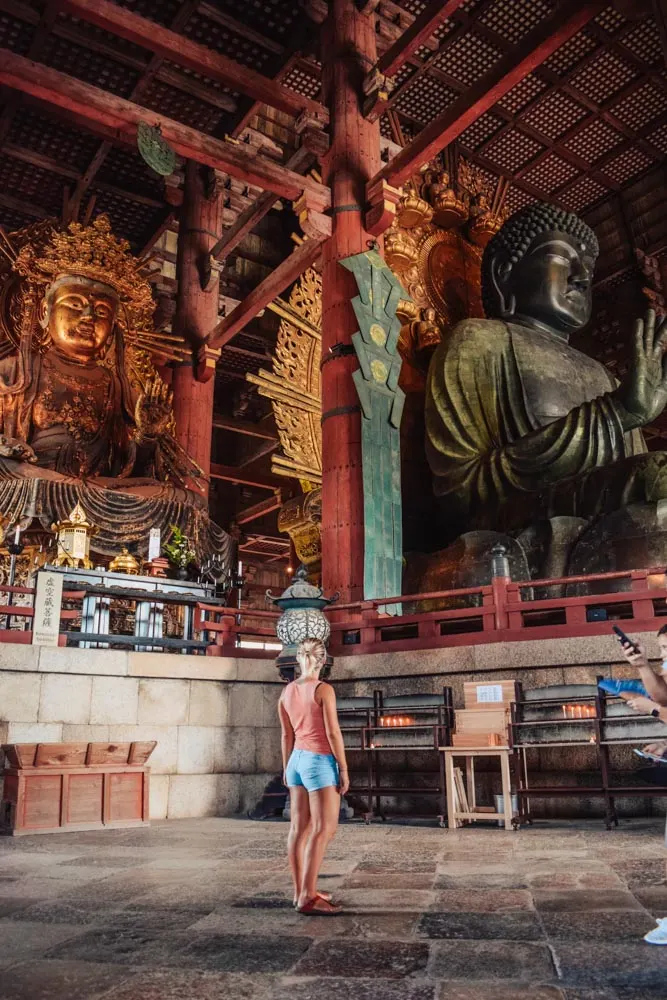Admiring the giant statues inside Todaiji temple in Nara, Japan