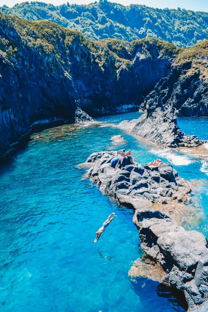Diving in the clear water of the Simao Dias natural pools of Sao Jorge Island