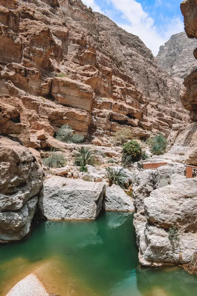 The emerald pools and golden rocks of Wadi Shab in Oman