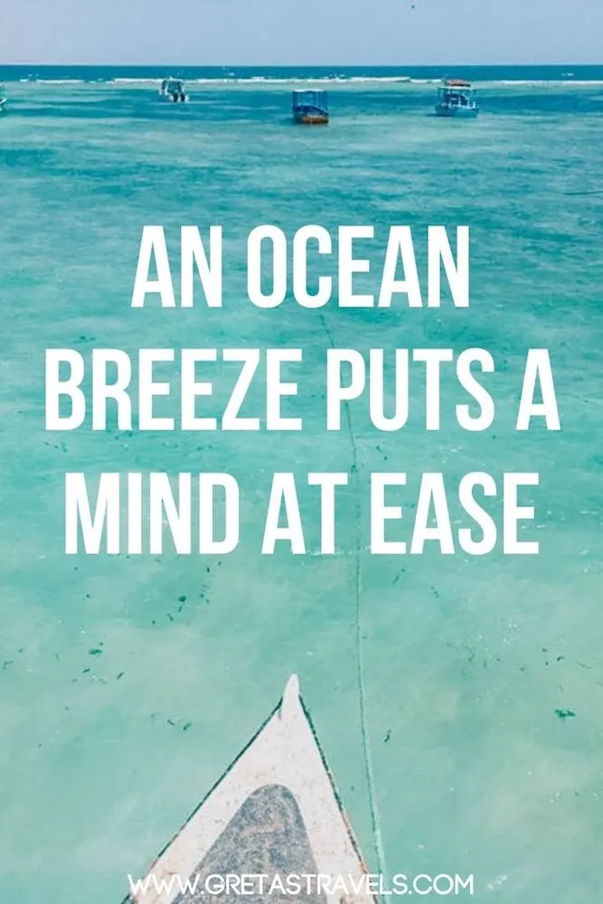 Photo of the beach and sea in Malindi with text overlay saying "An ocean breeze puts a mind at ease" - one of my favourite beach quotes!