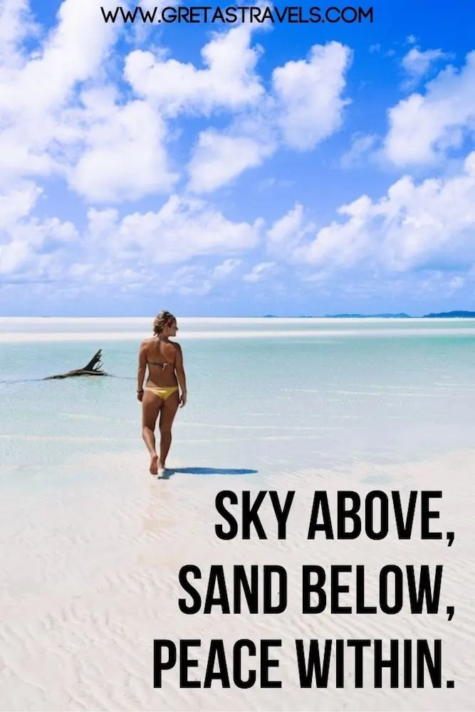 Photo of a girl walking Whitehaven Beach in Australia with text overlay saying "Sky above, sand below, peace within" - a beautiful quote about life at the beach