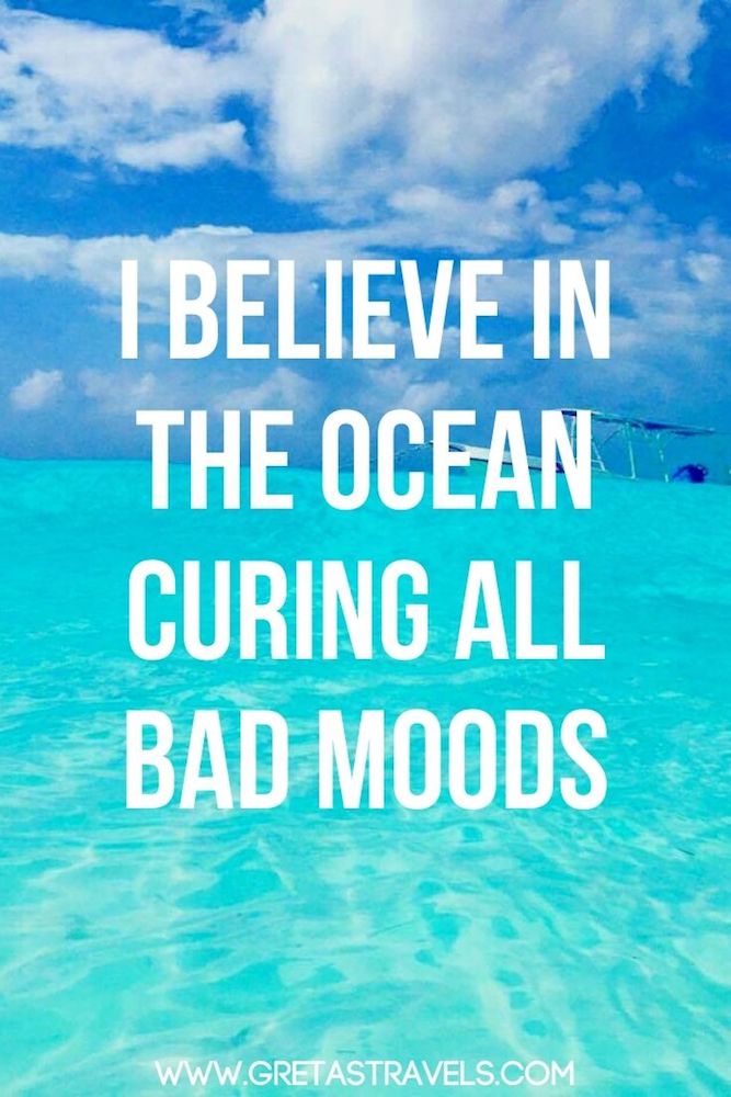 Photo of the crystal clear water of a tropical beach with text overlay saying "I believe in the ocean curing all bad moods" - an awesome beach quote