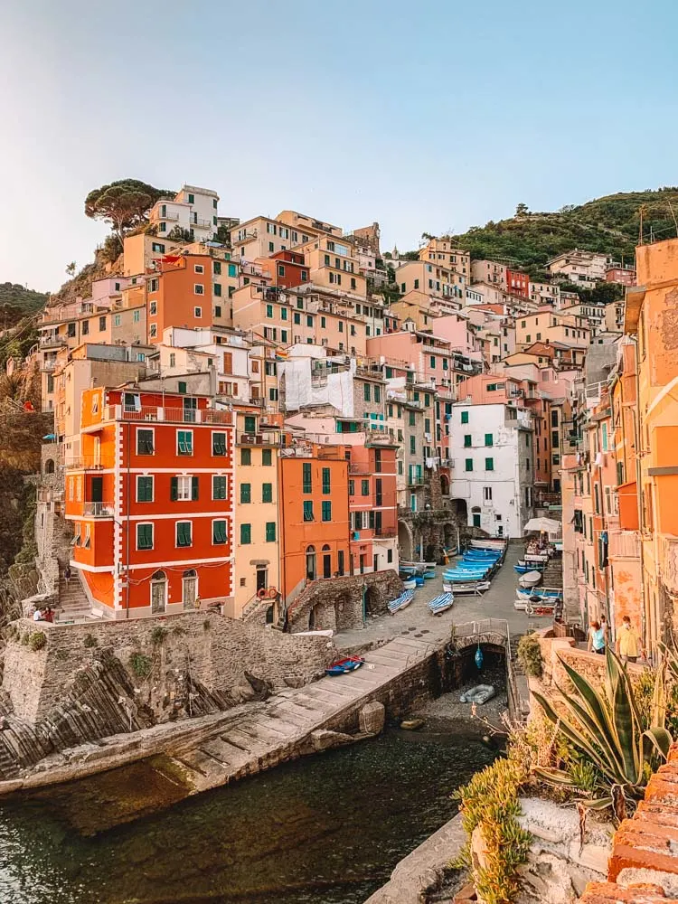 Sunset over the perched colourful houses of Riomaggiore in Cinque Terre, Italy
