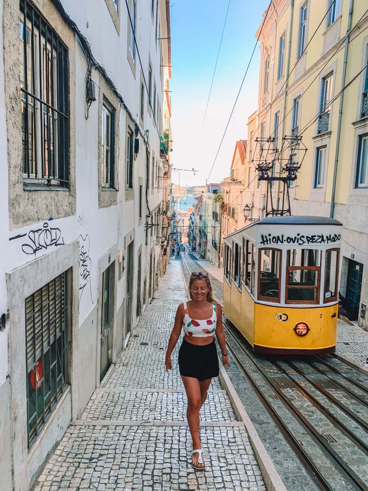Walking next to the famous Elevador da Bica in Lisbon, Portugal