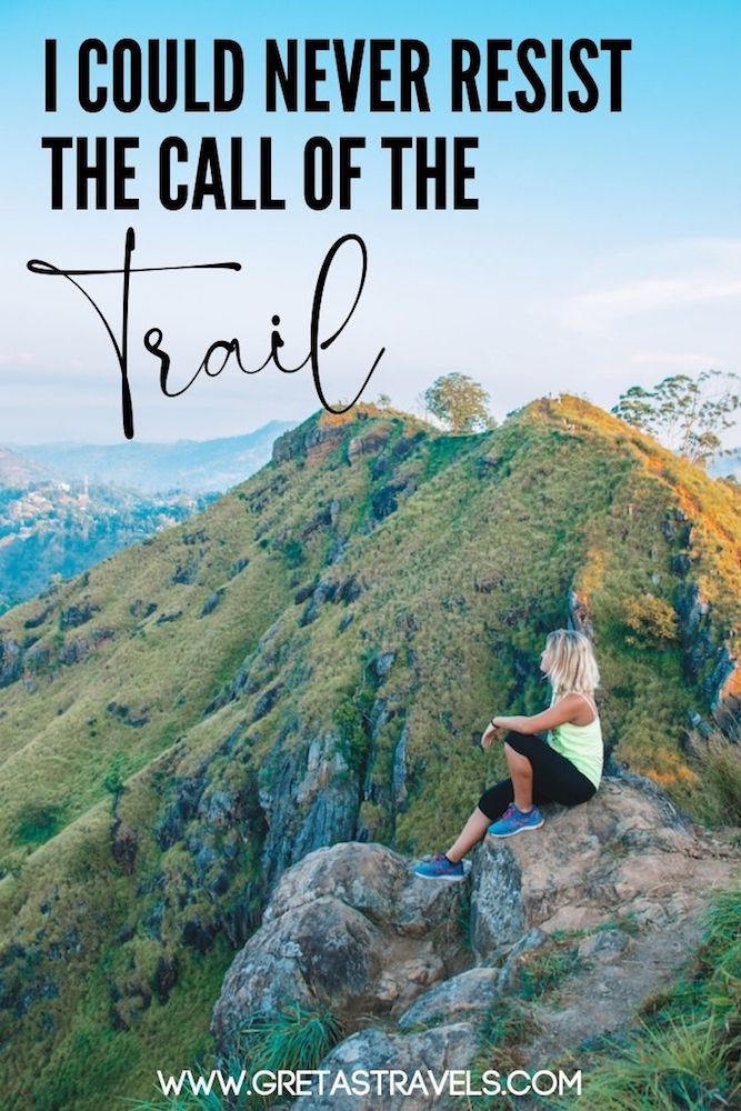 Photo of a blonde girl sat on a rock at Little Adams Peak in Sri Lanka watching the sunrise over the hills with text overlay saying "I could never resist the call of the trail"