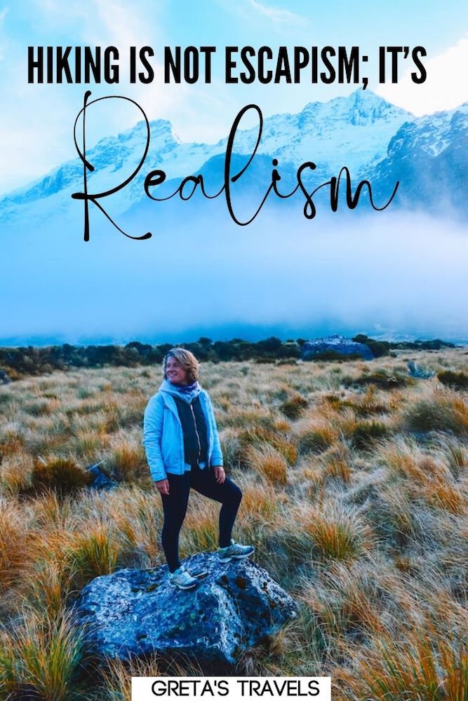 Photo of a blonde girl standing along the hiking trail of Hooker Valley Track, the mountains behind her, and text overlay saying "Hiking isn't escapism, it's realism"