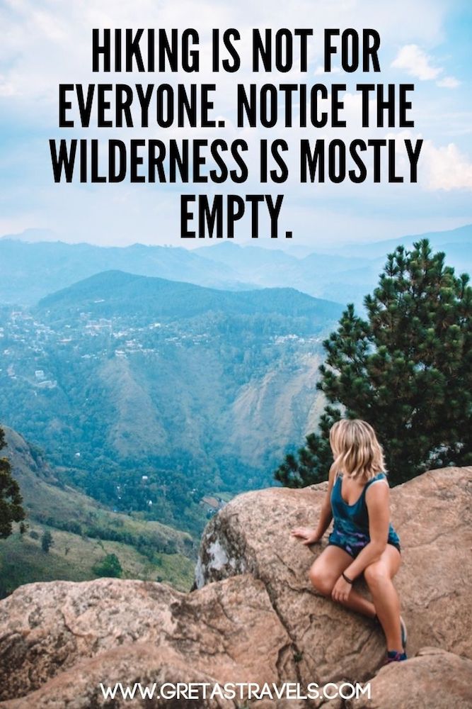 Photo of a blonde girl sitting at the top of Ella Rock in Sri Lanka overlooking the green hills with text overlay saying "Hiking is not for everyone, notice the wilderness is mostly empty" - a great quote about hiking, trekking and nature!