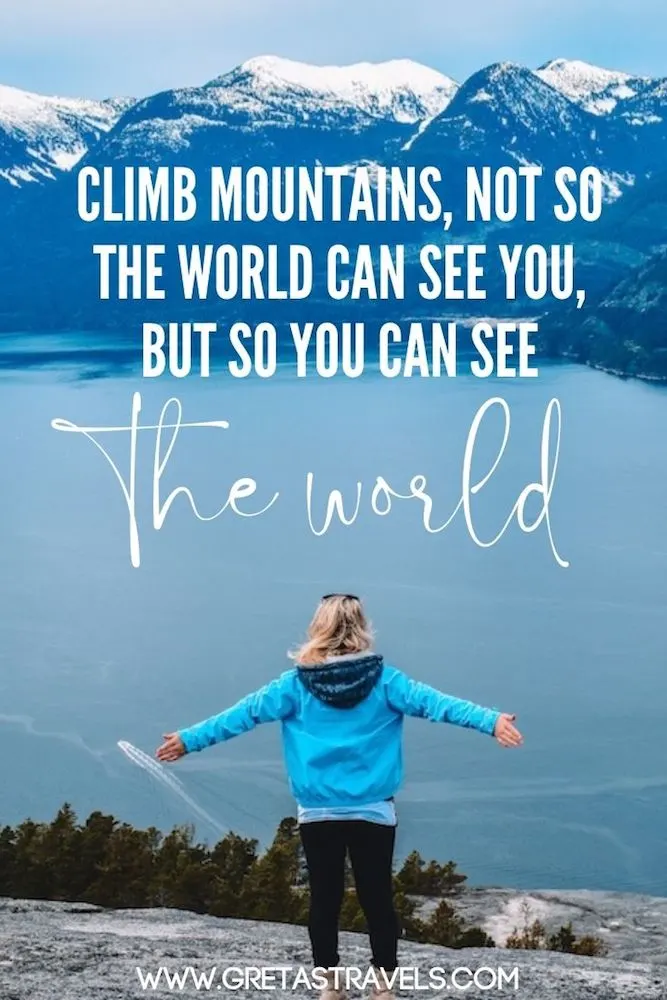 Photo of a blonde girl with a turquoise jacket standing with her arms open in front of the lake and mountain view at the top of Stawamus Chief Peak in Canada, with text overlay saying "Climb mountains, not so the world can see you, but so you can see the world" - one of my favourite hiking quotes!
