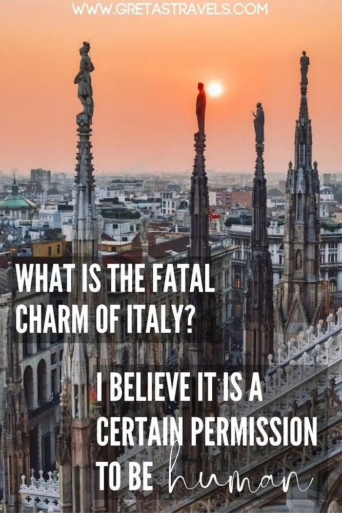 Photo of the spires of the Duomo Cathedral and the view beyond them with text overlay saying “What is the fatal charm of Italy? I believe it is a certain permission to be human" - a lovely quote about the Italian way of life