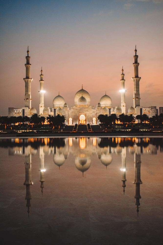 Sheikh Zayed Grand Mosque and its reflection at sunset as seen from Wahat AlKarama