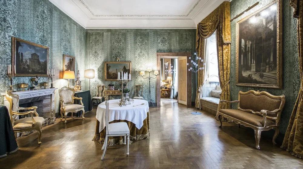 The dining and sitting room at Desiderata apartment in Rome, Italy - photo by Plum Guide