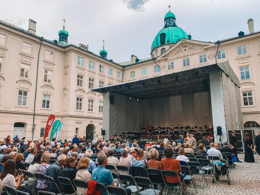 Listening to the Tyrolean Symphony Orchestra at Hofburg Palace in Innsbruck - one of the best things to do in Innsbruck in summer!