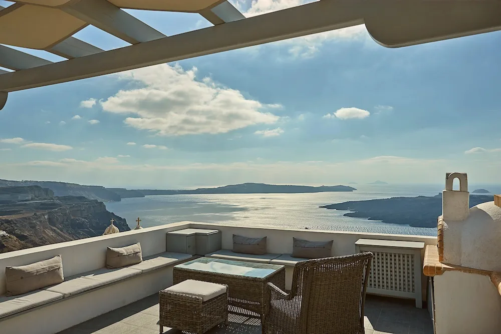 The outdoor lounge area and view at Caldera View in Fira, Santorini - photo by Plum Guide