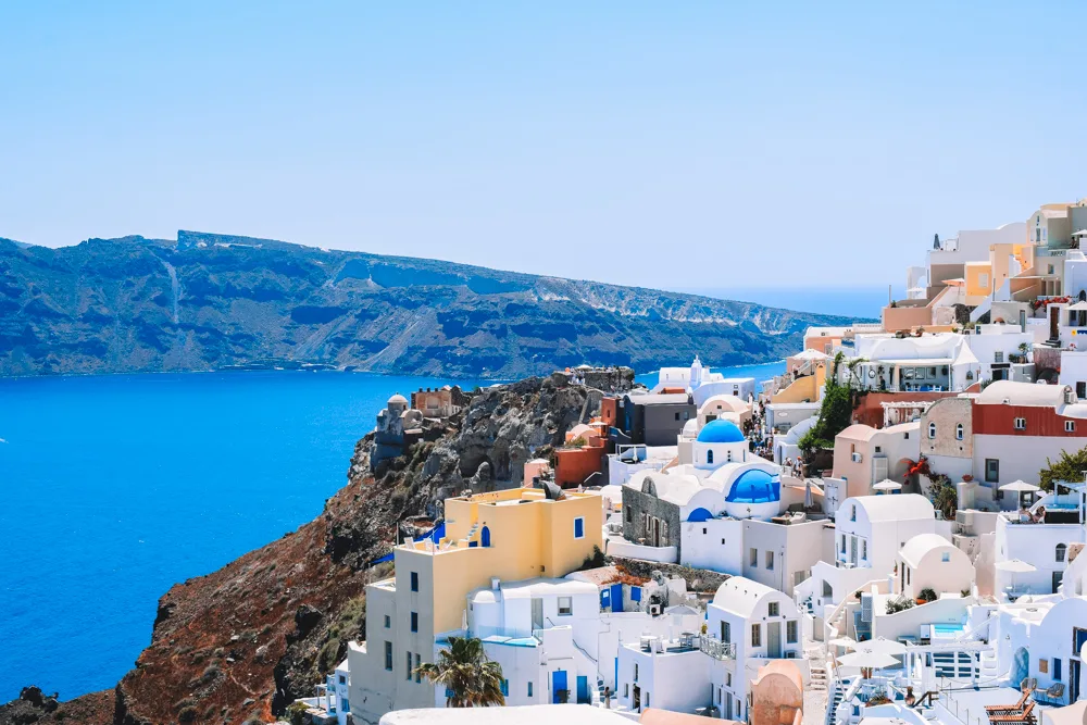 The iconic white houses, blue roofs and caldera views of Oia in Santorini, Greece