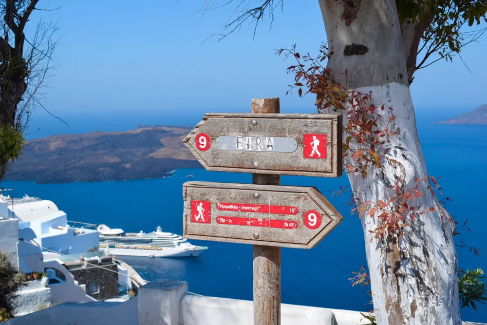 Signs along the Fira to Oia hike, marking the trail to follow