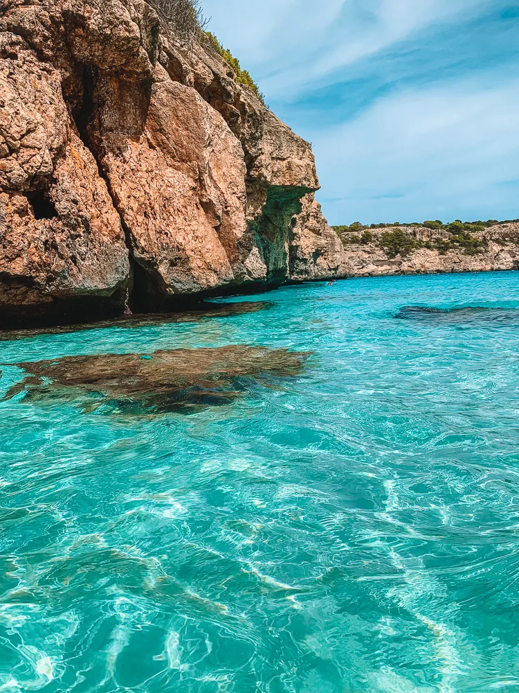 The crystal clear water and sandy cliffs of Calo des Moro in Mallorca