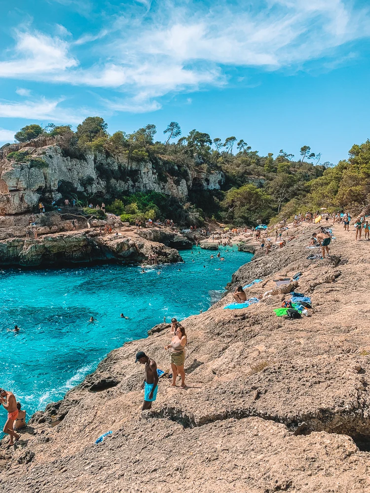 The turquoise sea and rocky shores of Cala S’Almunia in Mallorca