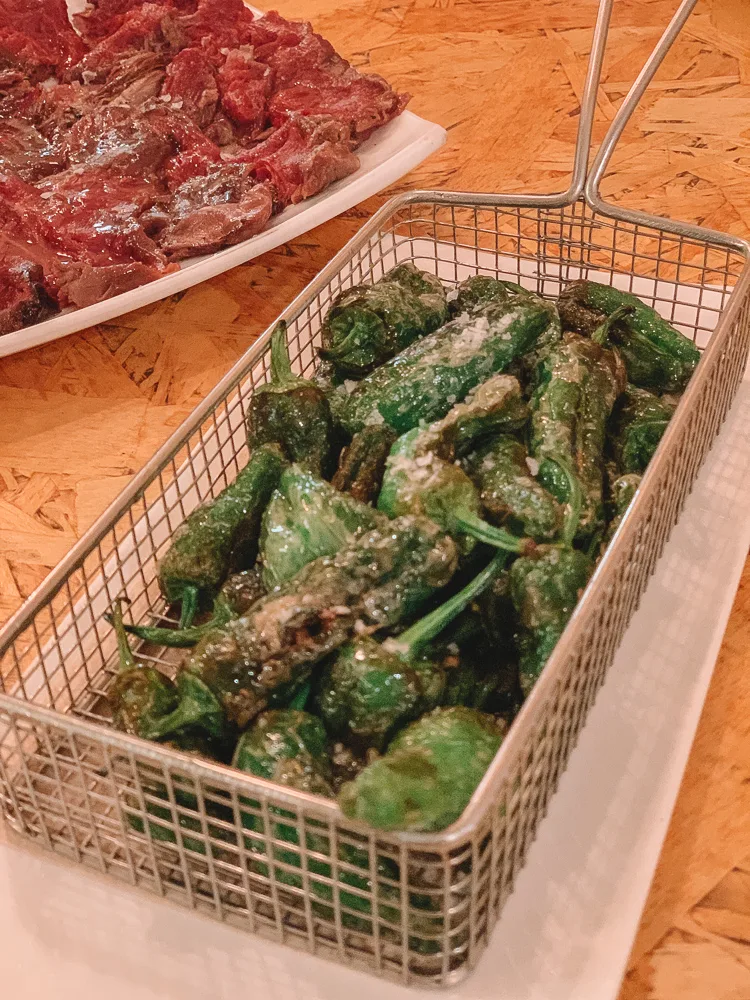 Tasting pimientos del padrón; a typical Spanish tapas that you can try in Mallorca