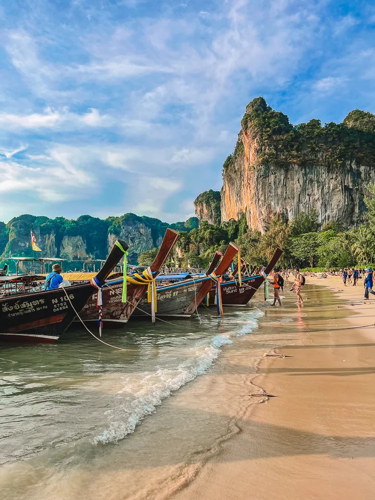 Long-tail boats lined up at Railay Beach West in Krabi, Thailand