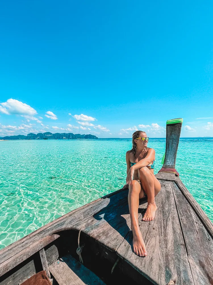 Enjoying a longtail boat tour in Krabi, Thailand, with Railay Beach behind me - one of the best things to do in Railay Beach