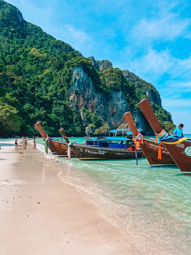 Long tail boats lined up at Monkey Beach in Ko Phi Phi Don, Thailand