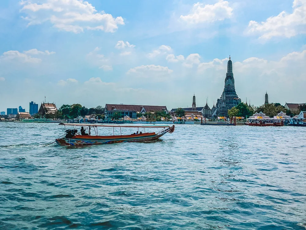 A longtail boat cruising along the Chao Phraya river in Bangkok, Thailand