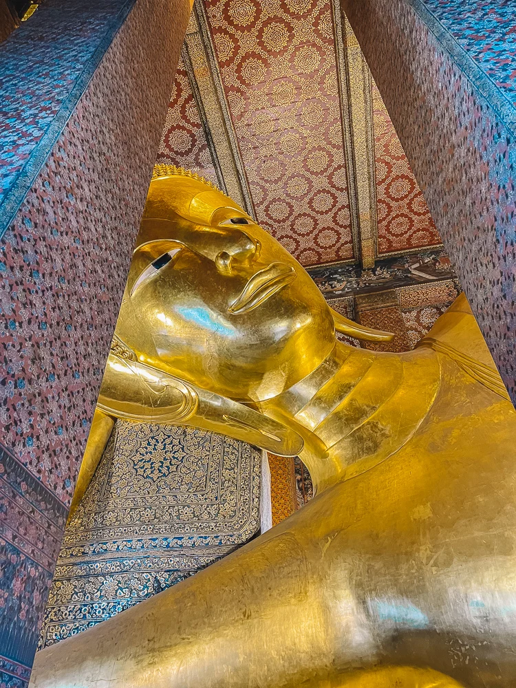 The giant Reclining golden Buddha of Wat Pho in Bangkok, Thailand