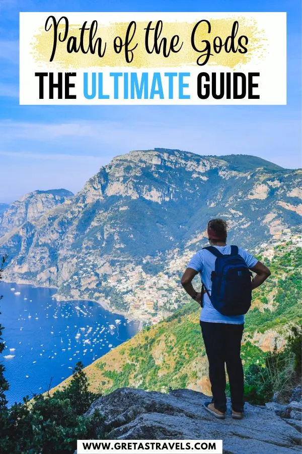 Photo of a guy in a white t-shirt and shorts standing in front of Positano and the Amalfi Coastline with text overlay saying "Path of the Gods, the ultimate guide"