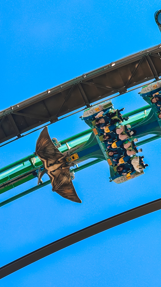 Flight of the Dinosaur coaster riders suspended mid-air at Universal Studios Osaka Japan.