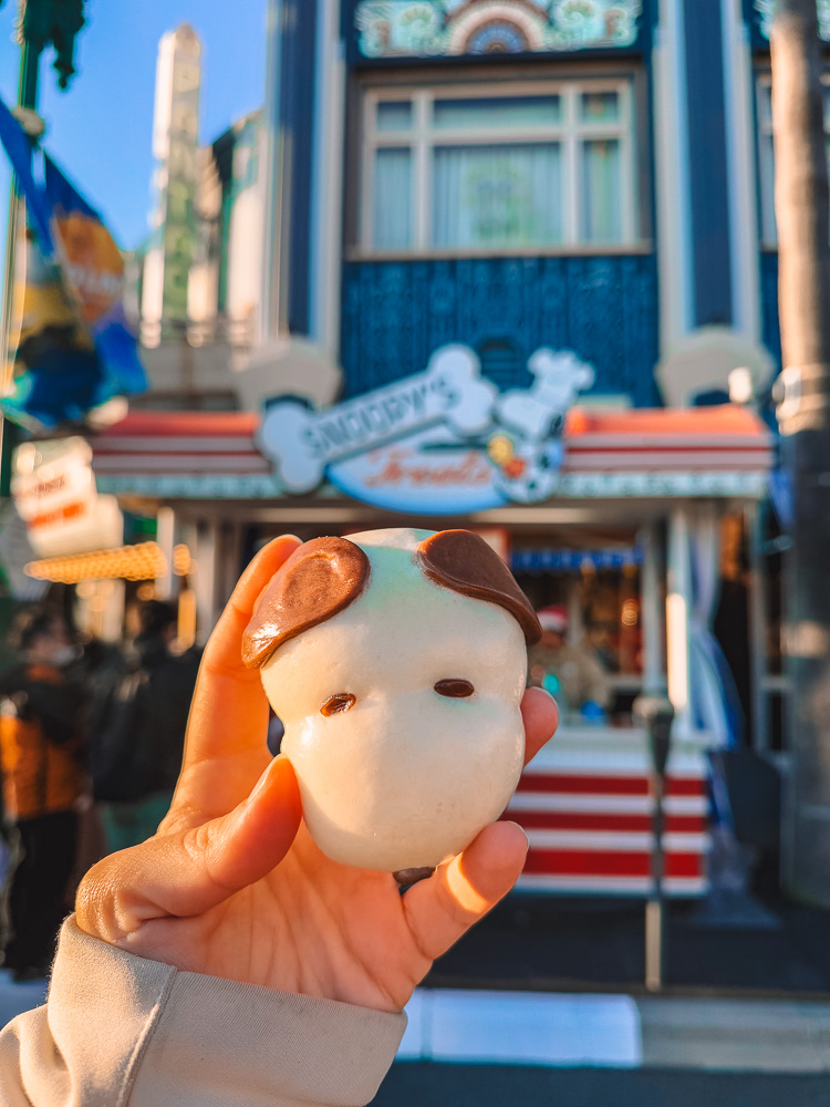 Snoopy-themed steamed bao held up at Universal Studios Osaka Japan.