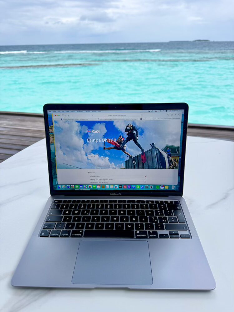 Studying for our PADI Open Water from the deck of our Water Villa
